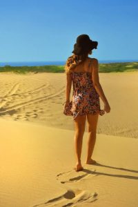 woman walking on beach sand