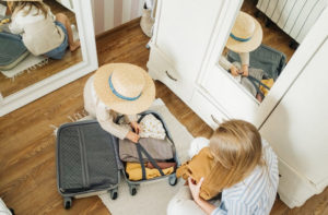 https://www.pexels.com/photo/a-woman-and-a-child-packing-a-suitcase-4784047/