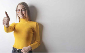 https://www.pexels.com/photo/photo-of-woman-in-yellow-turtleneck-sweater-blue-denim-jeans-and-glasses-giving-the-thumbs-up-3768997/